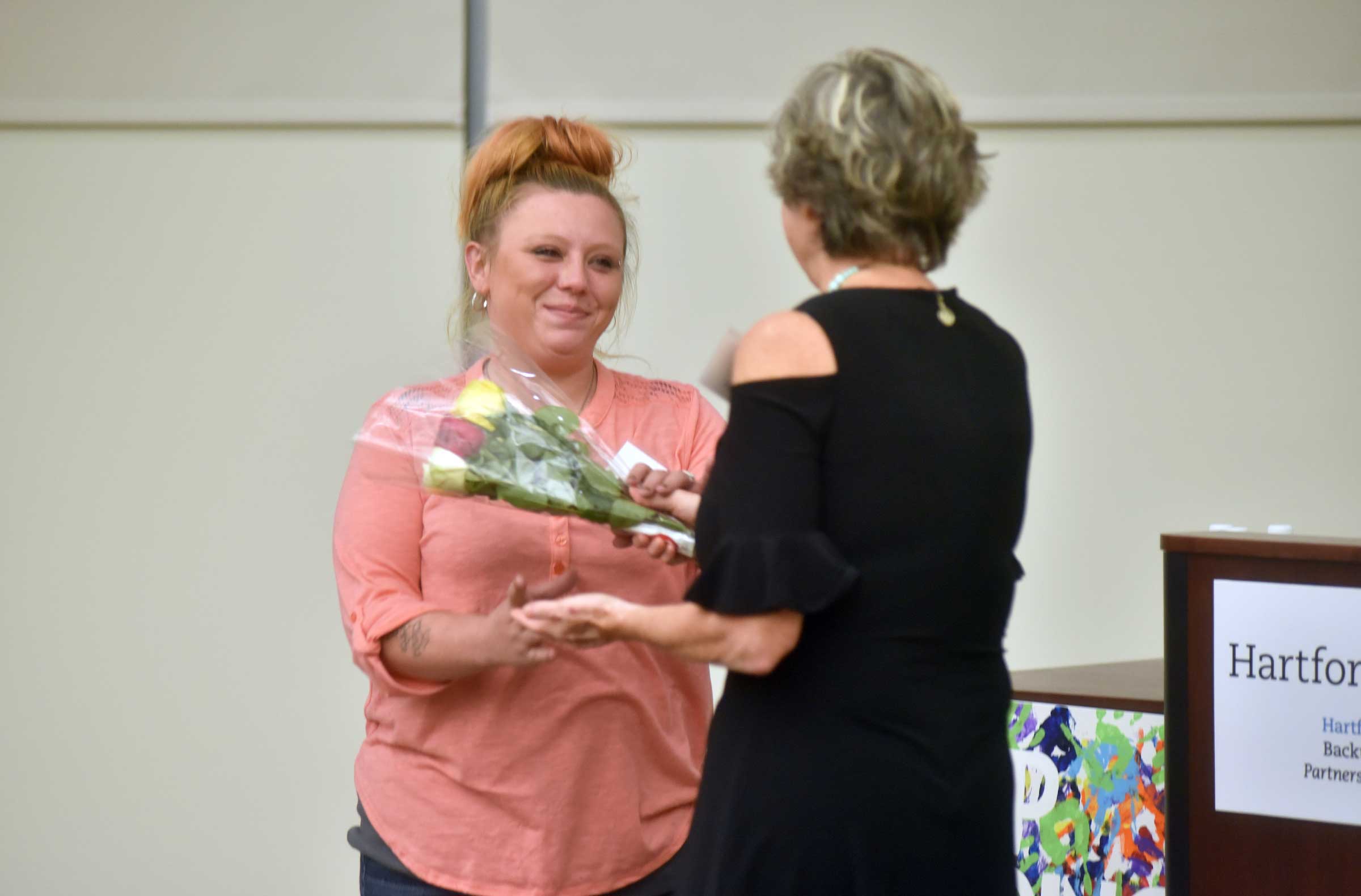 Tiffany accepting flowers from Pat Rehmer.