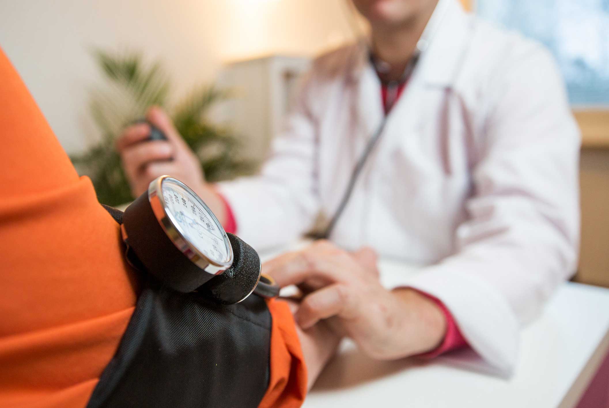 Woman getting blood-pressure reading.