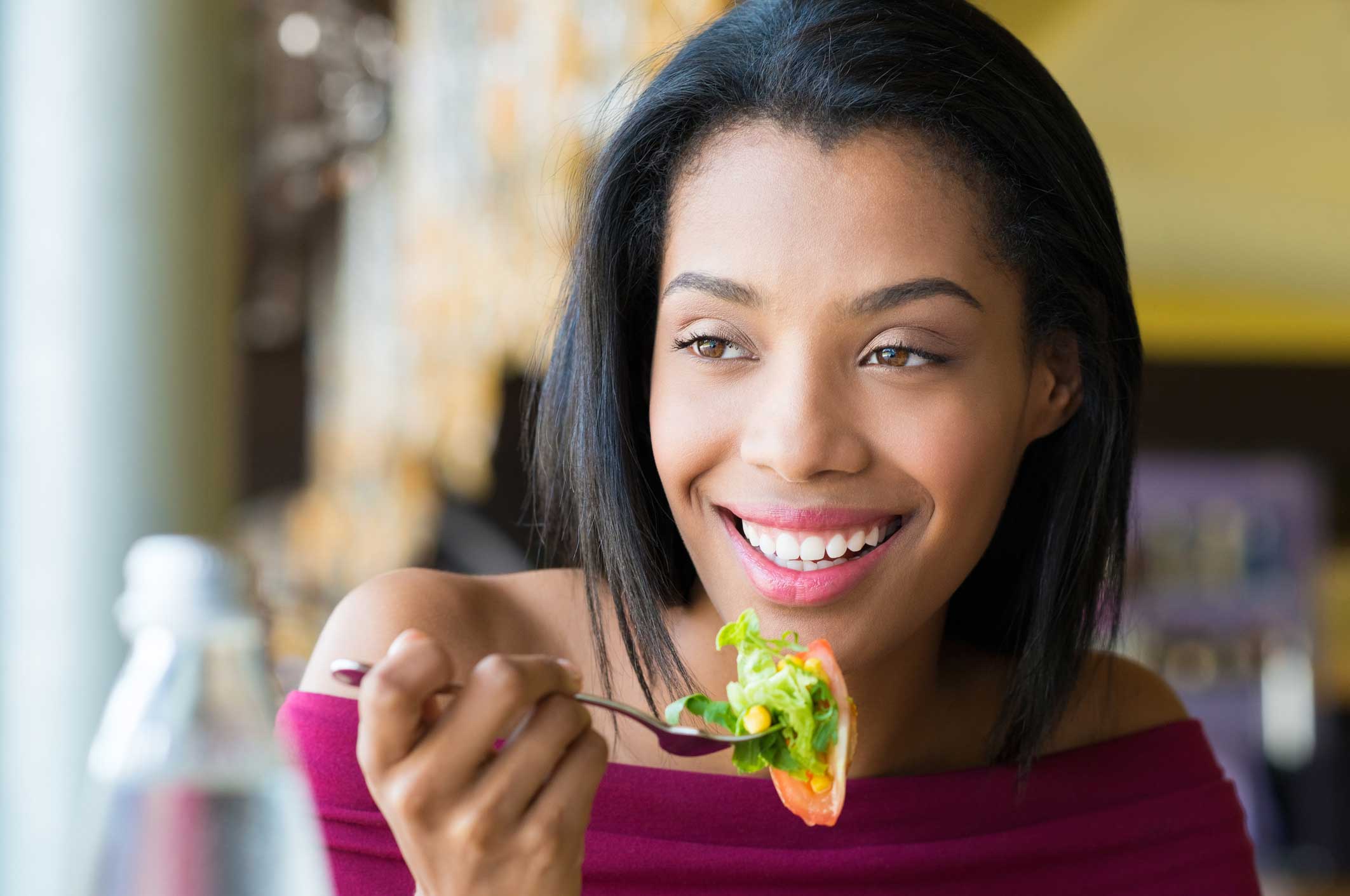 Woman eating salad.