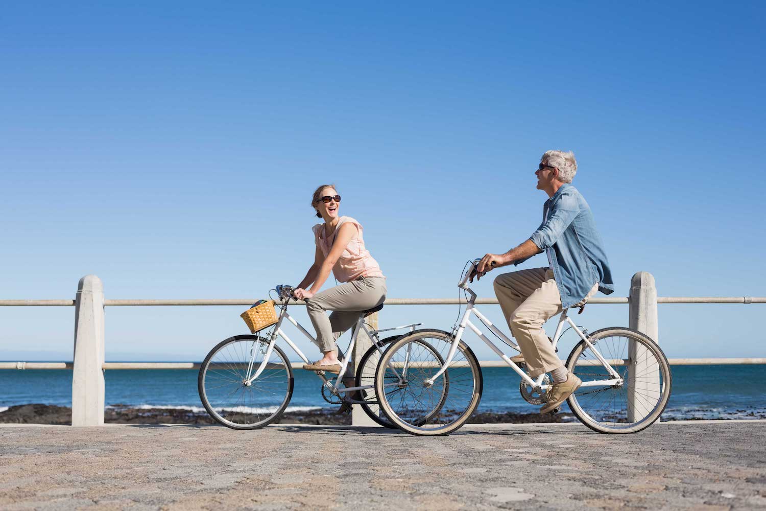 Middle-aged couple on bikes.