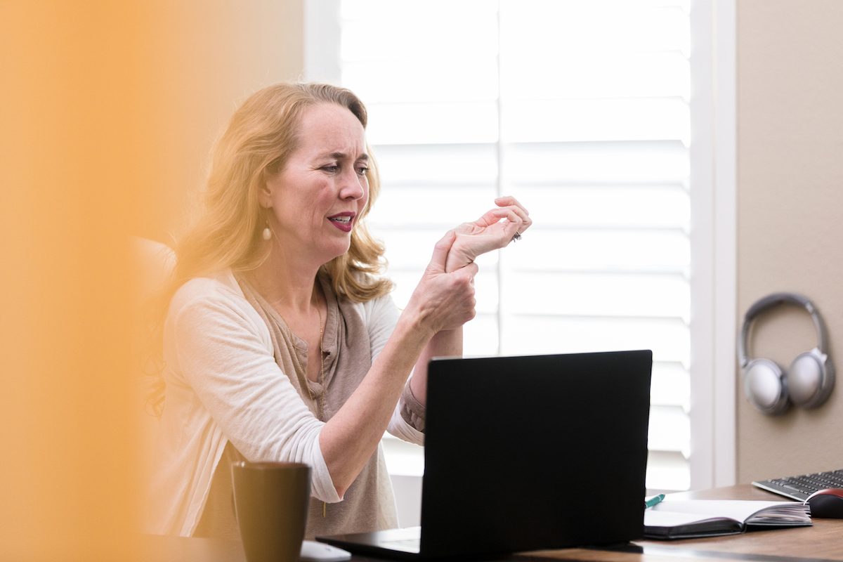 Businesswoman suffers from Carpal Tunnel Syndrome