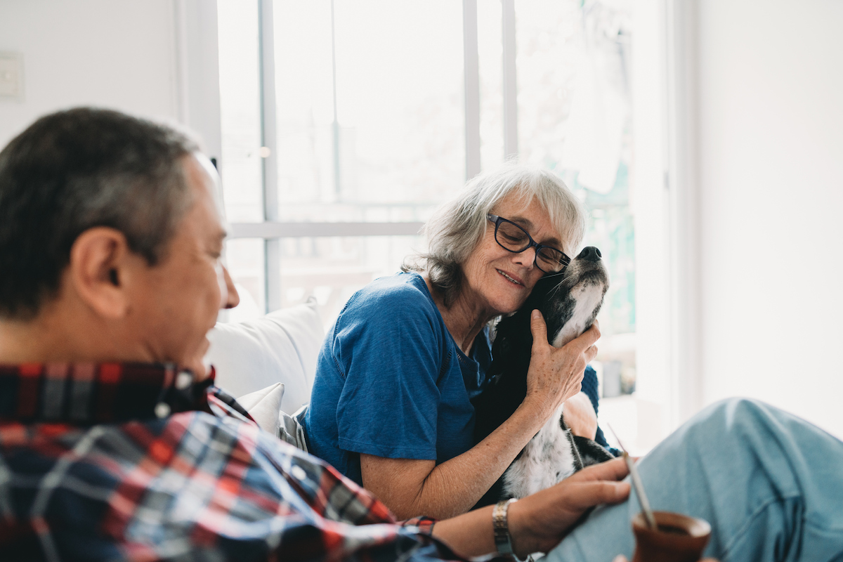 Mature couple spending time together with their dog at home