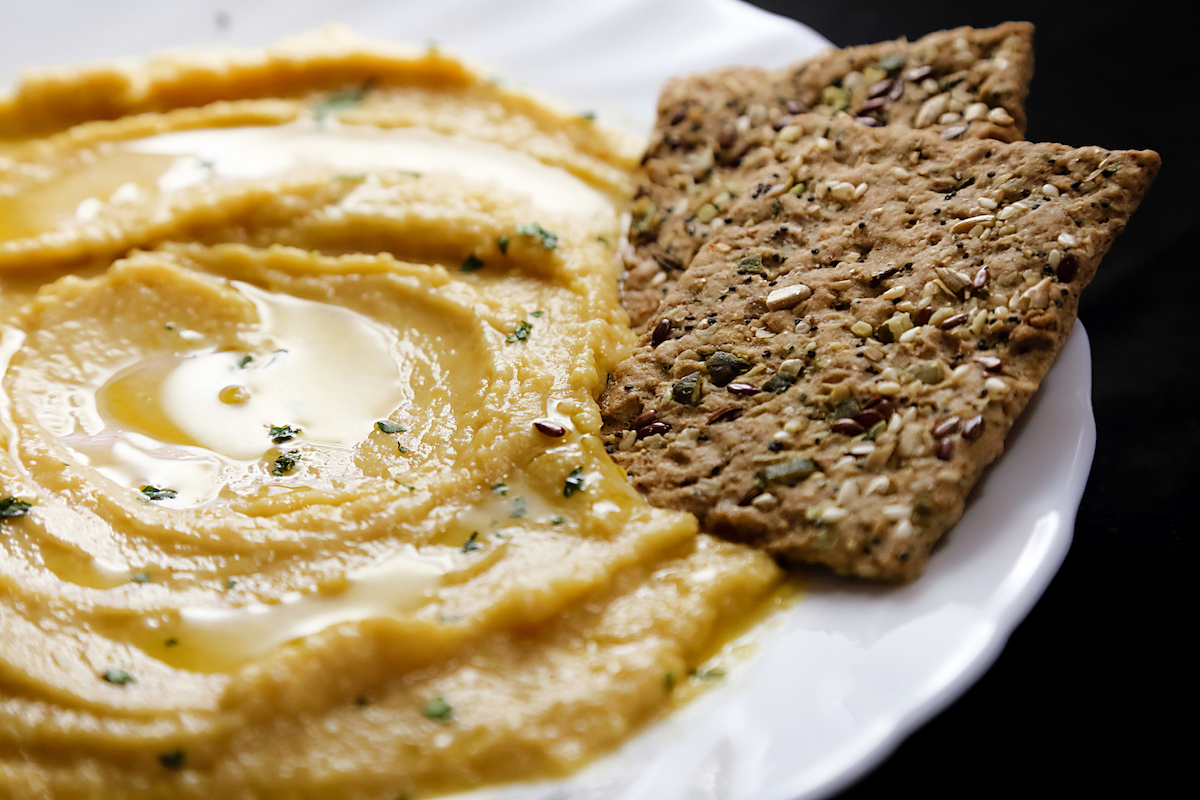 Homemade hummus with lemon, herbs, virgin olive oil and integral flatbread