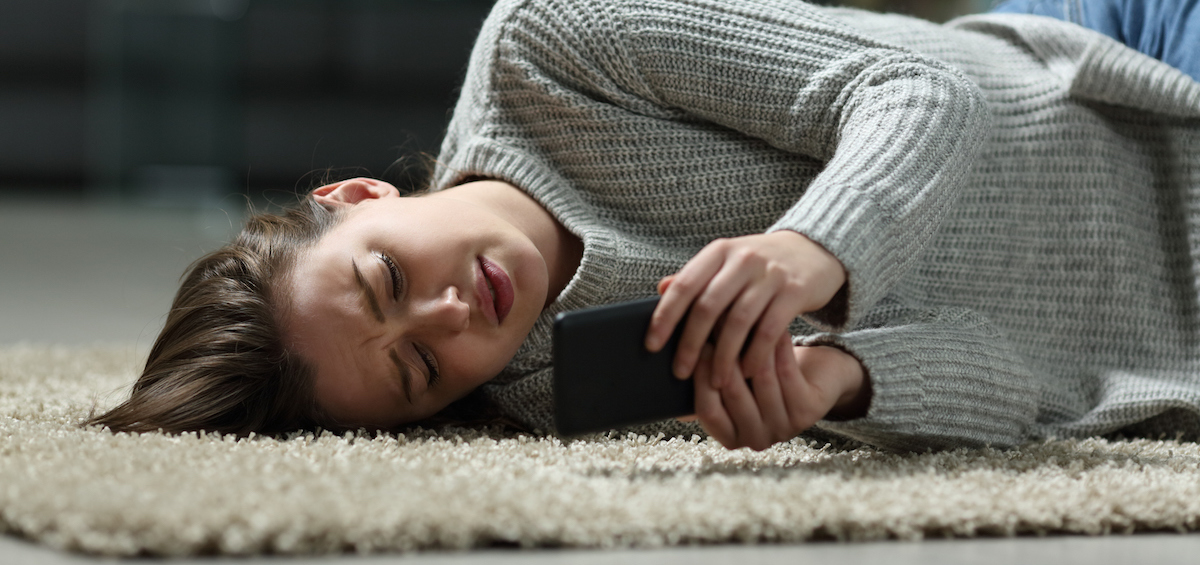 Sad teen reading bad news on smartphone
