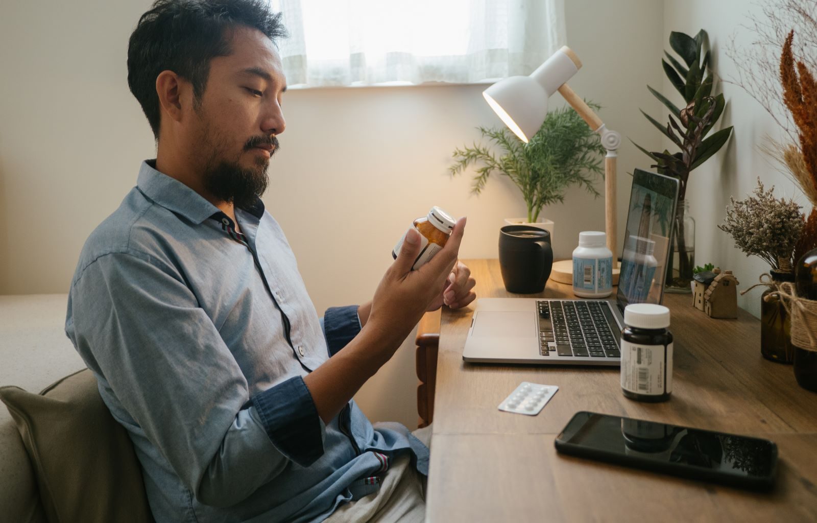 Man looks at an opioid prescription bottle.