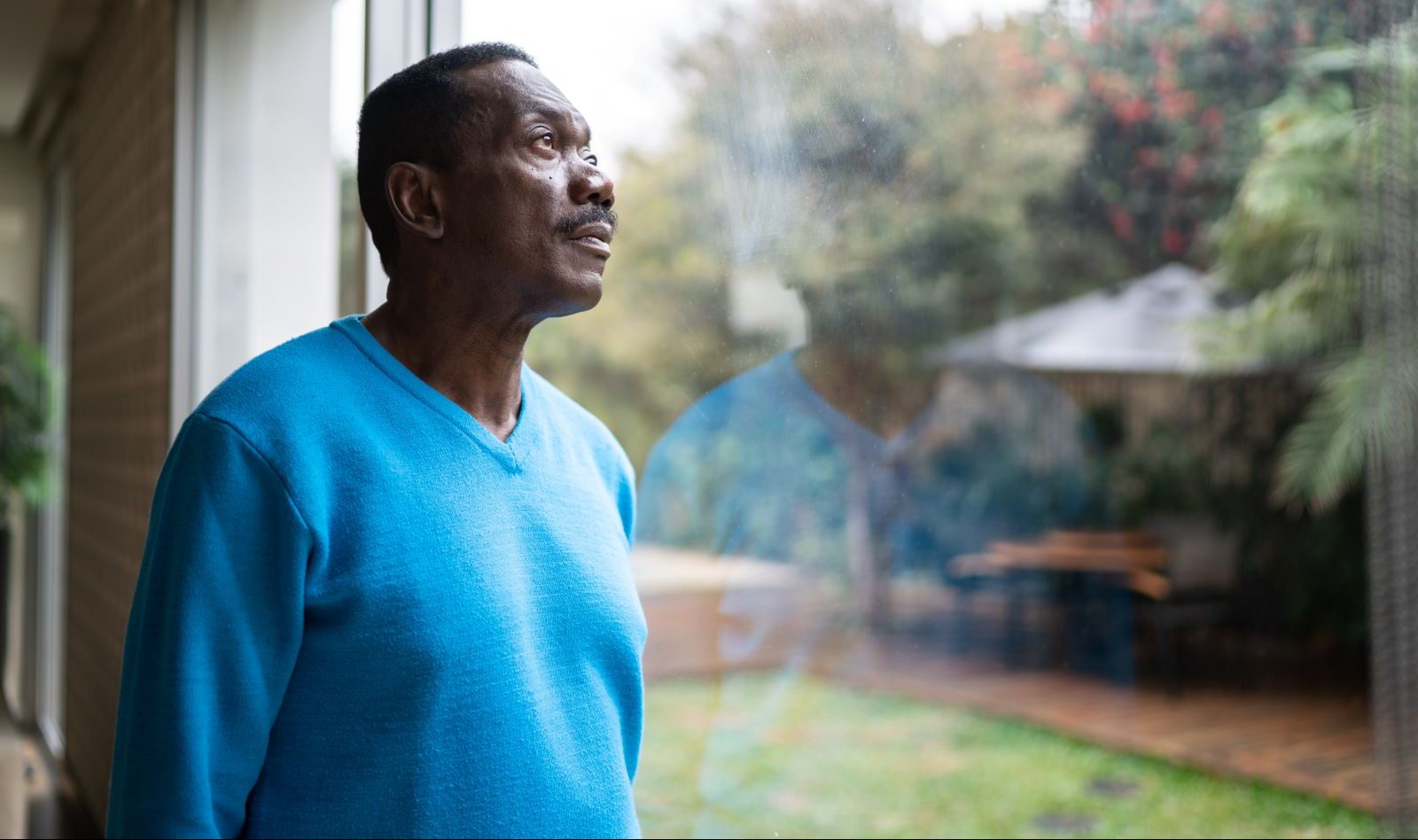 A person with depression stares out the window.