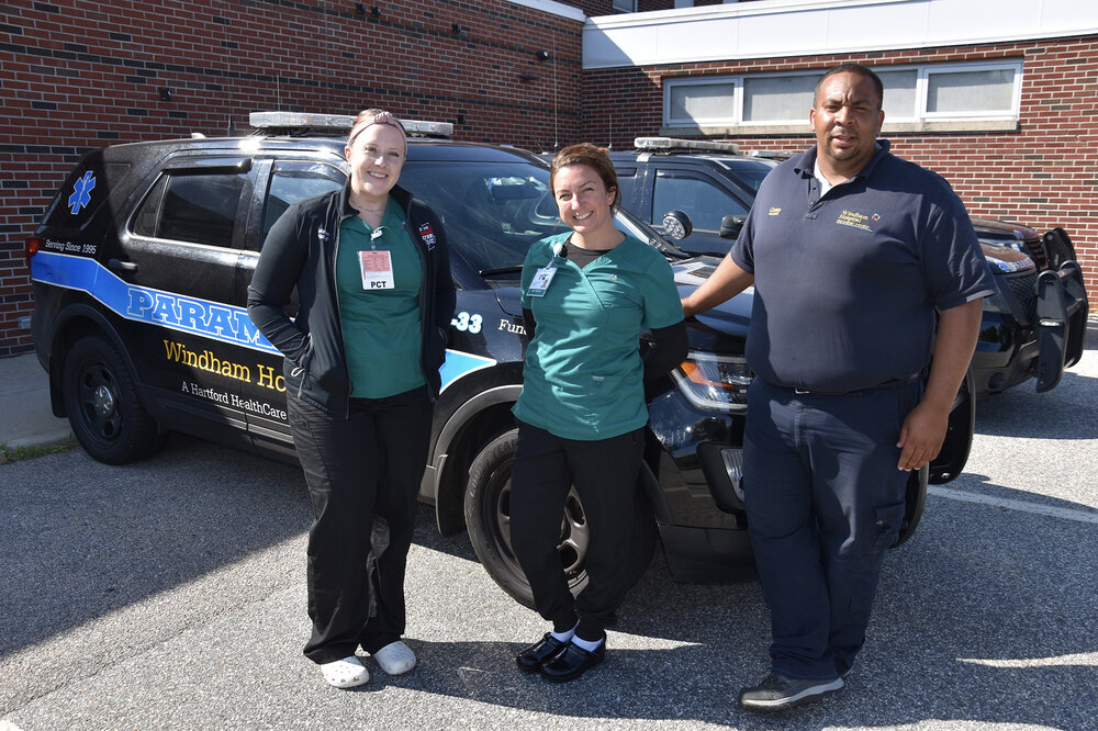 Windham Hospital Paramedic Corey Curtis-Gray, right, and a team of Emergency Department colleagues including Melanie Sak, PCT, left, and Meagan Johns, ED Tech, center, recently assisted a woman who had been rushed to the hospital by her family after her tracheostomy tube had detached.
