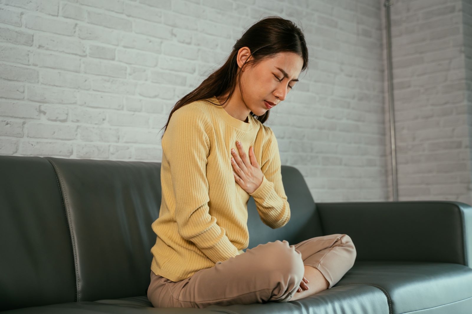 A woman suffers from acid reflux.