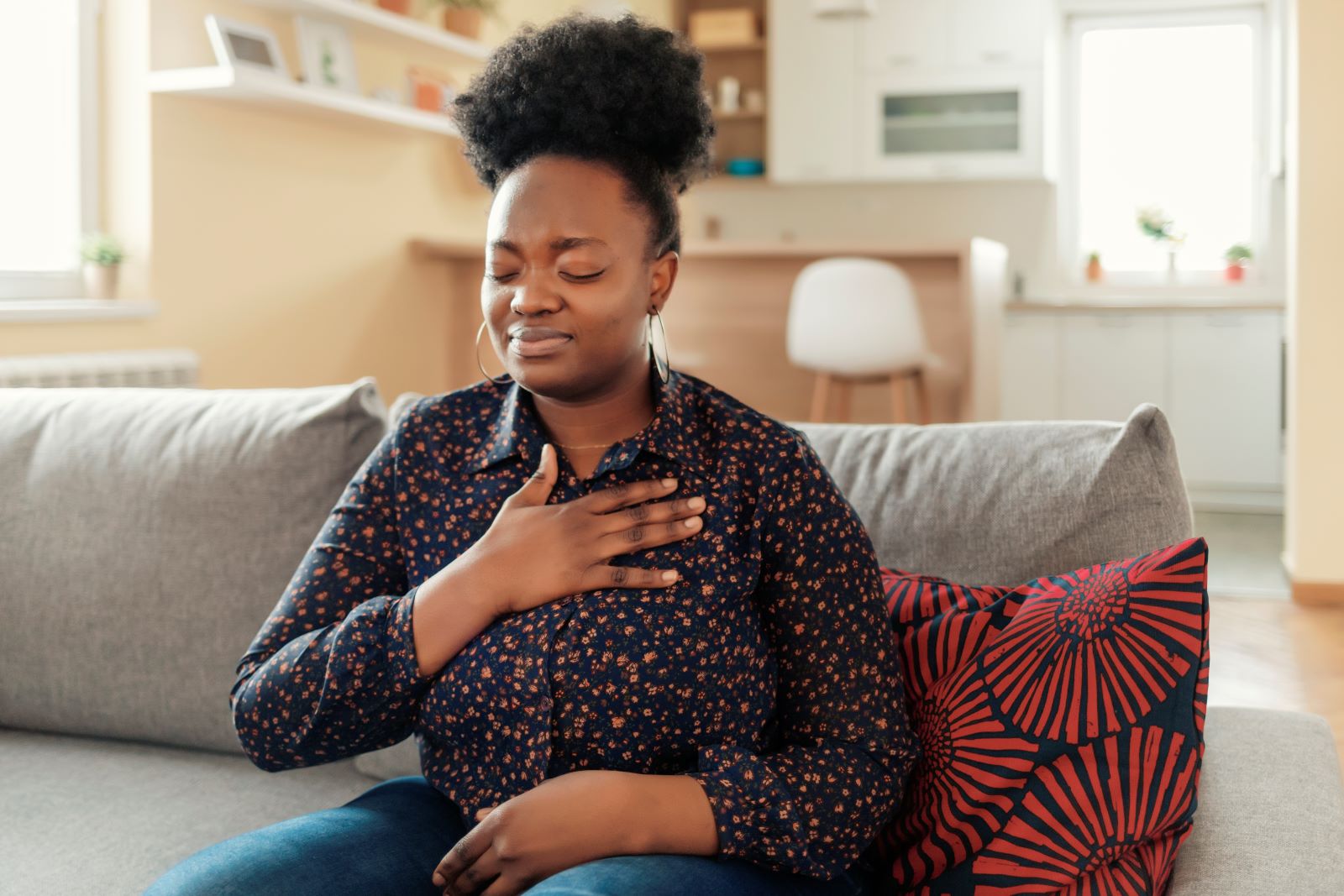 A woman suffers from chest pain.
