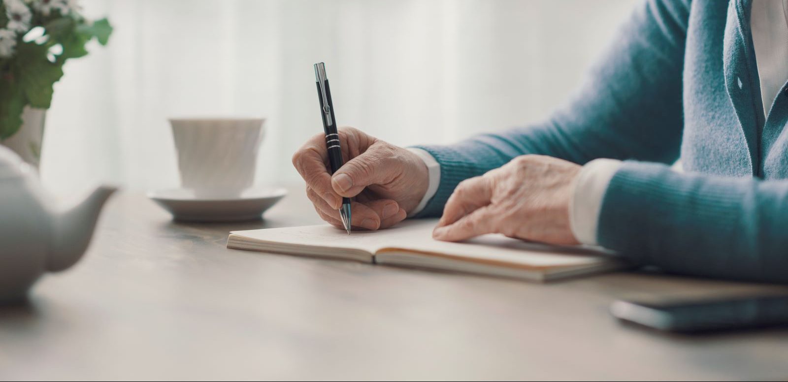 A person writes an obituary.