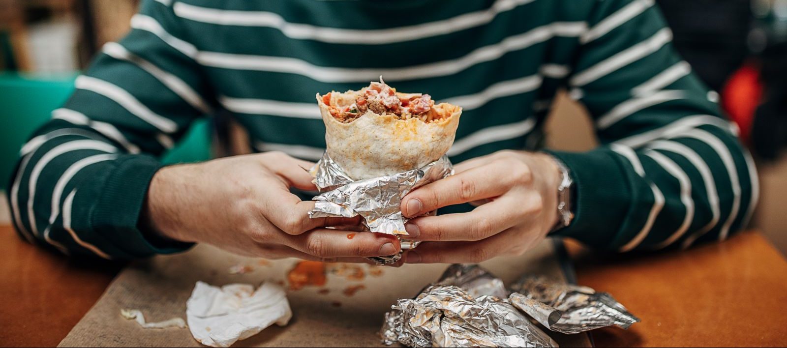 A person eats ultra-processed food.
