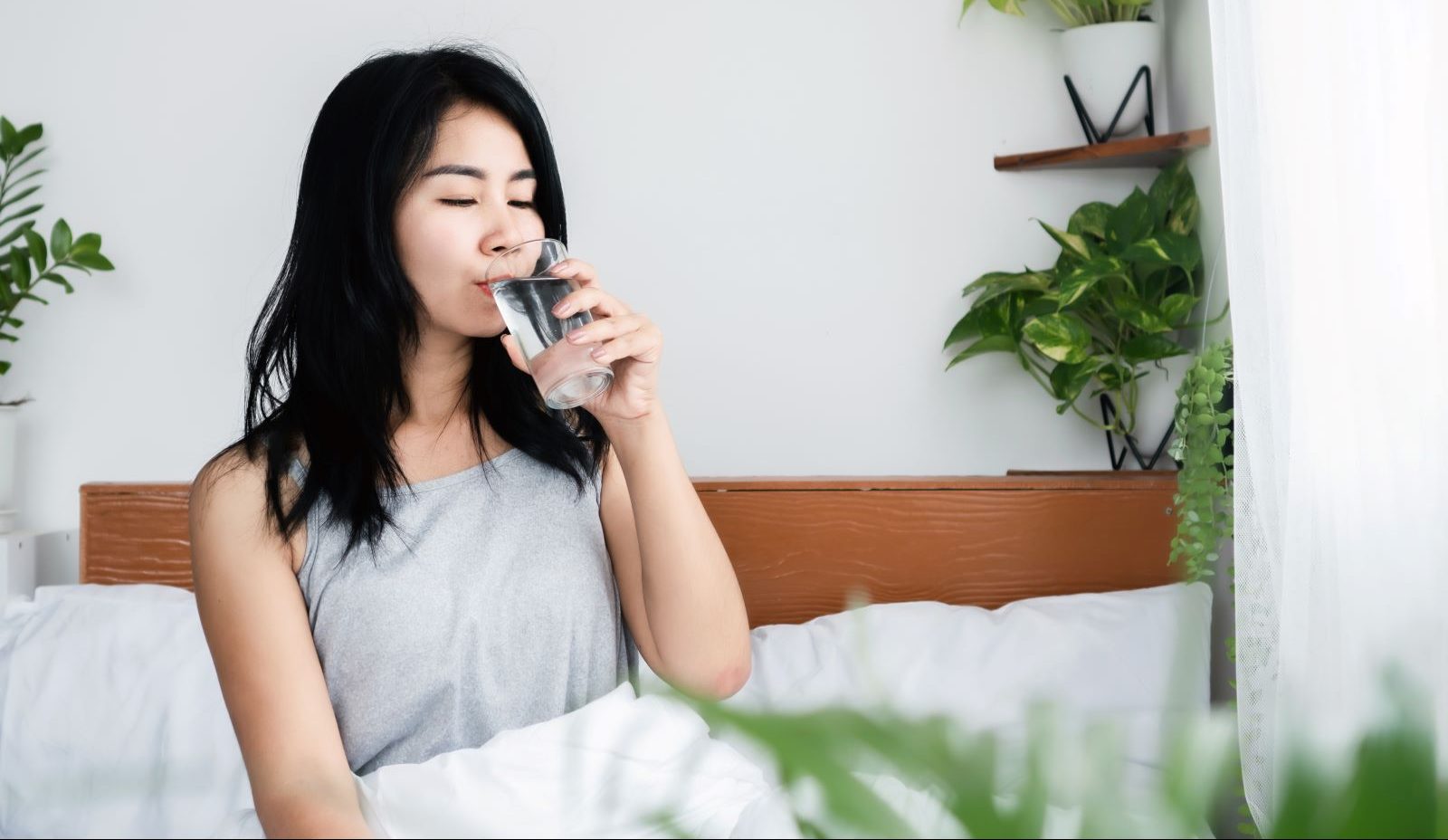 A person drinks water, hoping to avoid waterborne diseases.