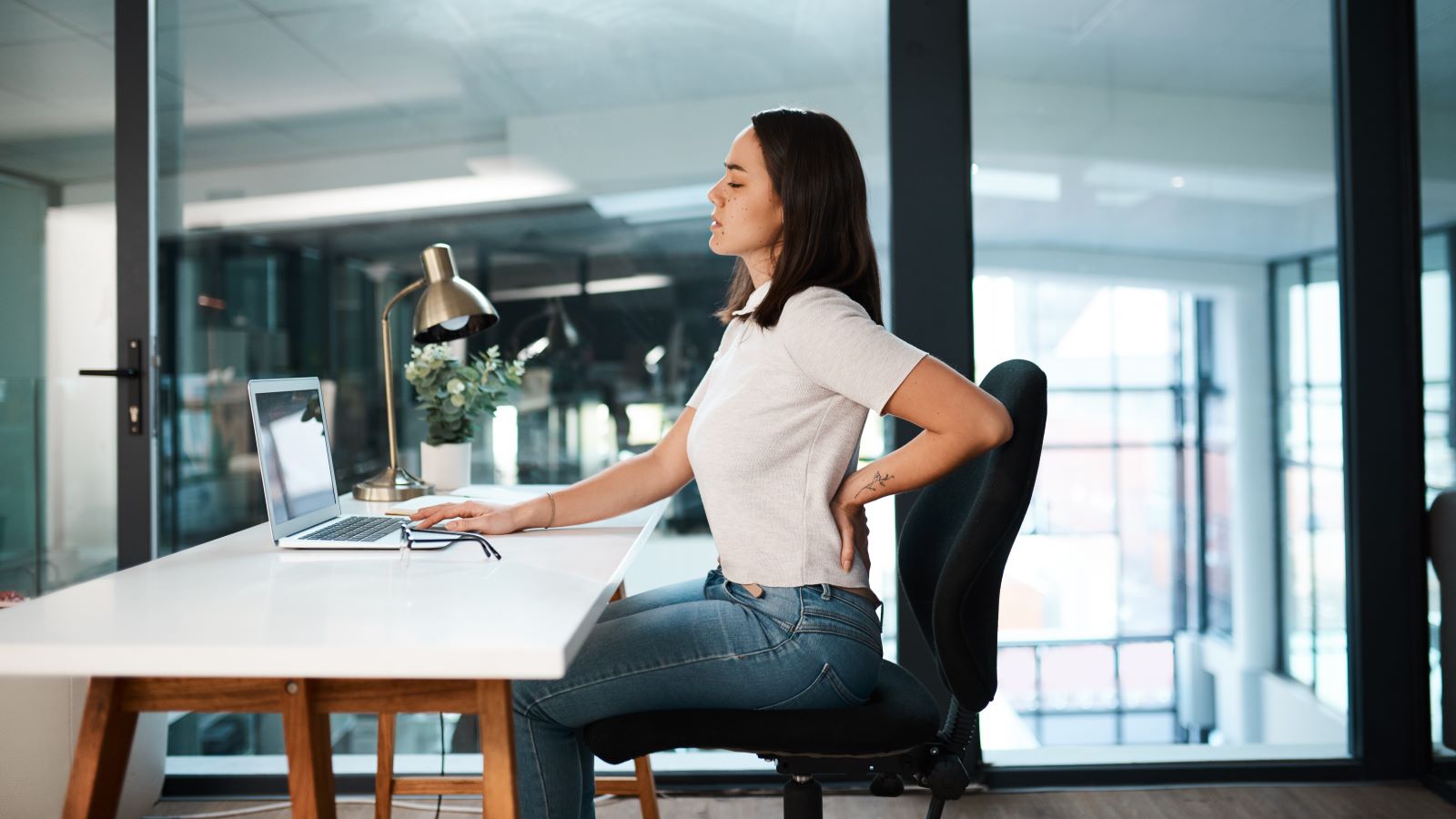 Sitting at a desk all day can take a toll, leading to discomfort and strain over time. Here's how to improve your posture at work.