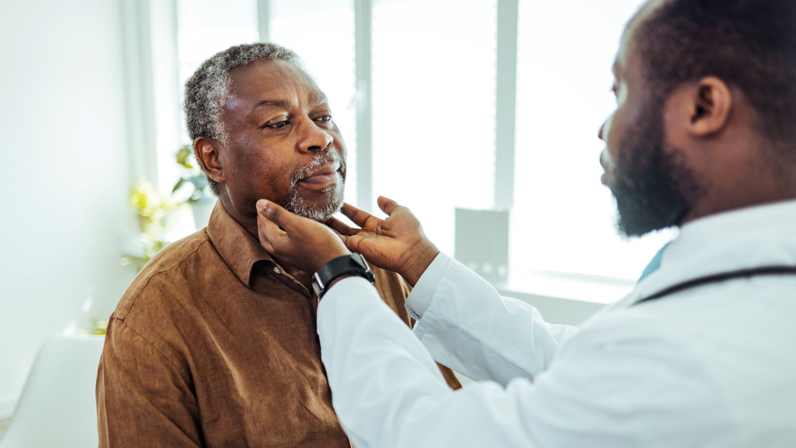 doctor examining patient for head and neck cancer
