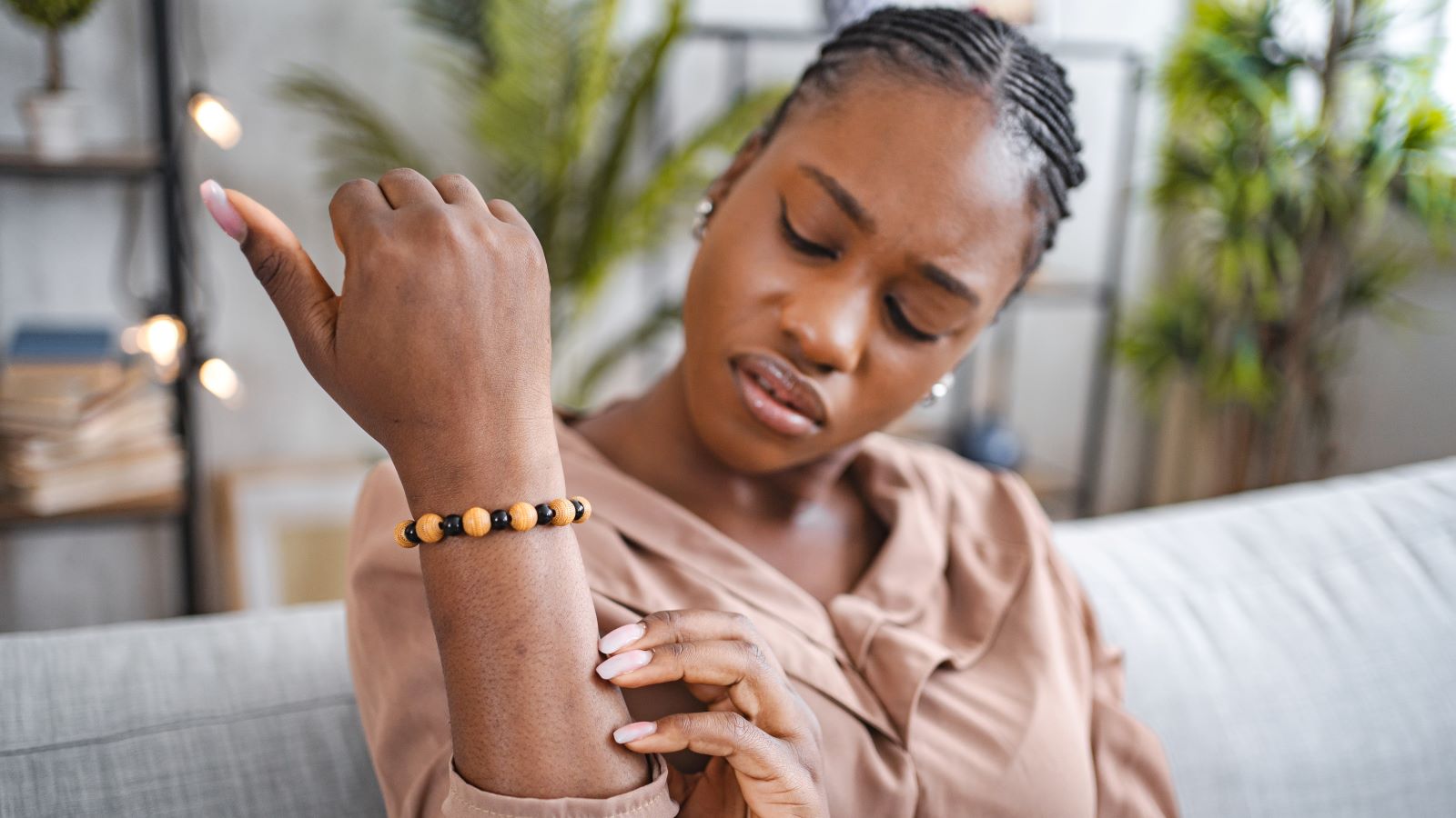 woman looking at her skin for a cancerous mole